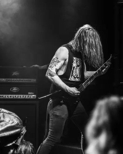 Dane Holloway playing guitar on stage in black and white
