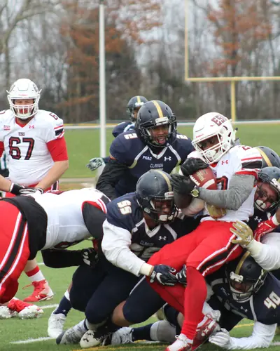 Football players colliding at the line of scrimmage
