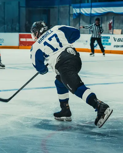 Hockey player carrying the puck up the ice